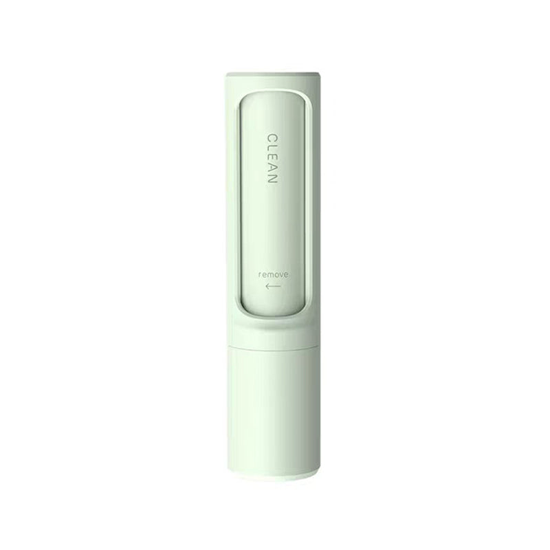 Mint green reusable pet hair remover brush, front view on a white background