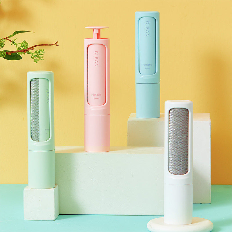 Reusable pet hair remover brushes in pink, mint, blue and white on display stands