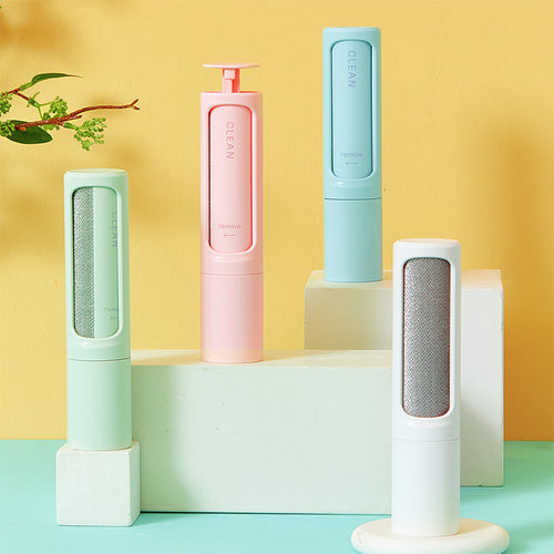 Reusable pet hair remover brushes in pink, mint, blue and white on display stands