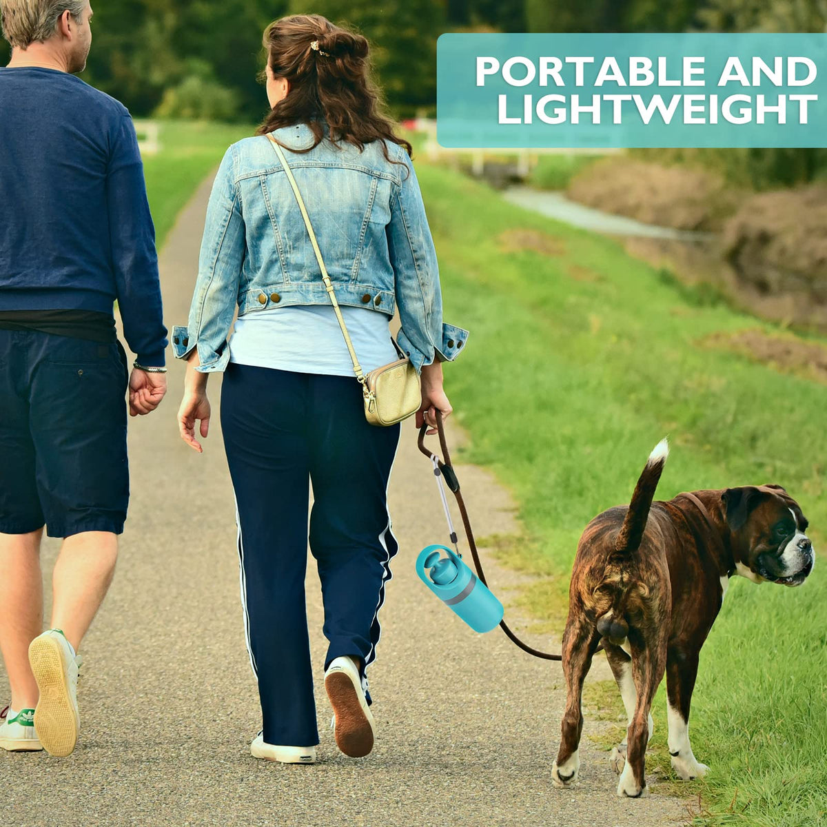 Couple walking a dog with a lightweight poop scooper clipped to the leash