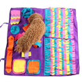 Dog using a colorful fabric snuffle mat for dogs, foraging for kibble
