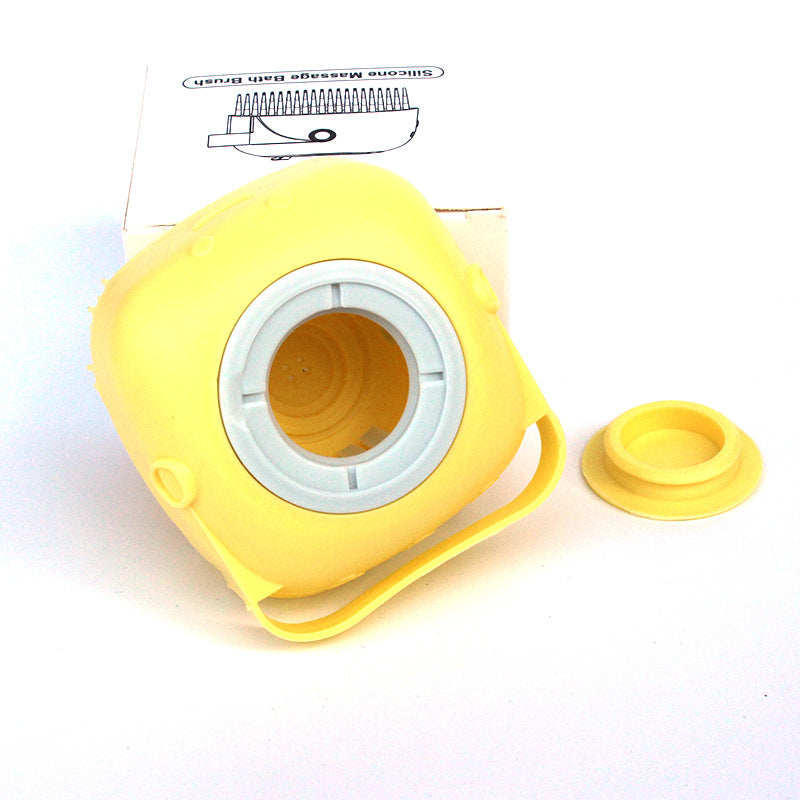 Yellow round silicone bath brush with open shampoo reservoir and cap