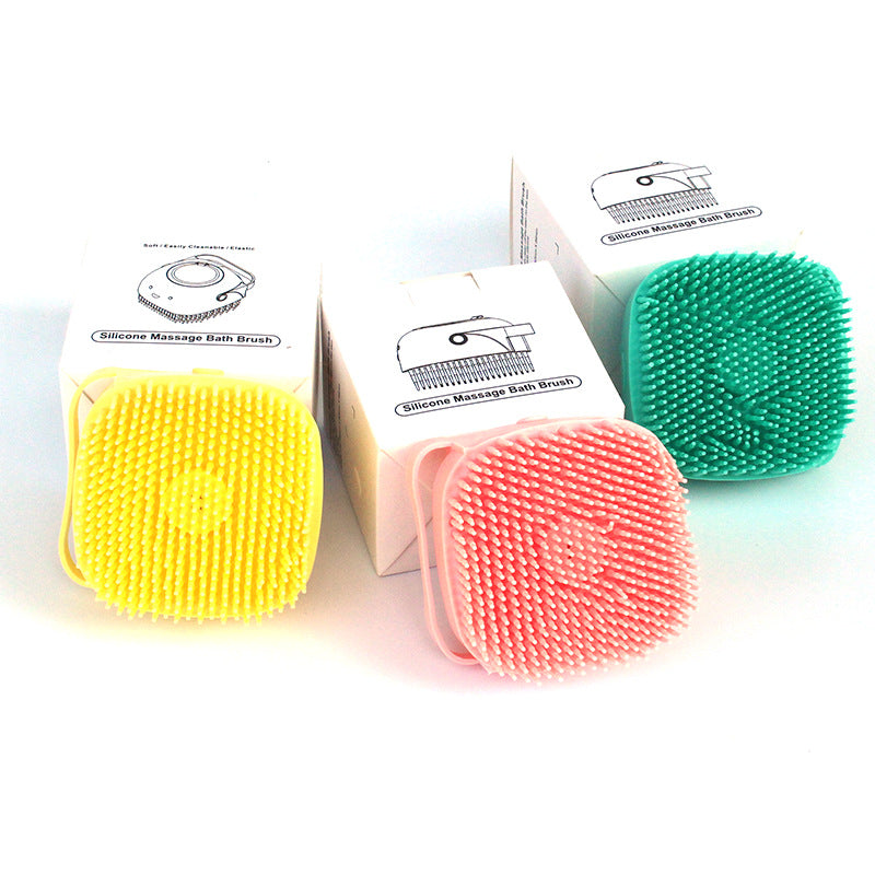 Square silicone dog shower brushes in yellow, pink and green with boxes