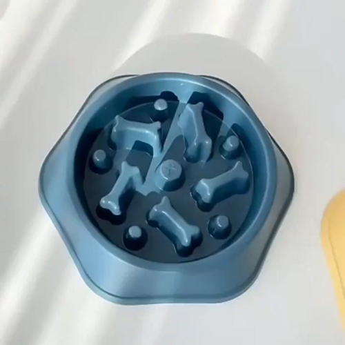 Blue slow feeder dog bowl with raised bone-shaped maze ridges, top view